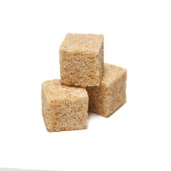 Brown cane sugar cubes isolated on white