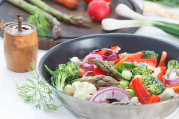 Mixed vegetables with carrots, broccoli, cauliflower and asparagus. Tasty garnish for healthy vegetarian meal.