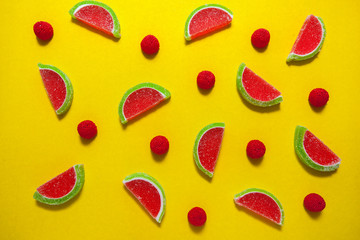 Fruit jelly segments in the form of watermelon on yellow