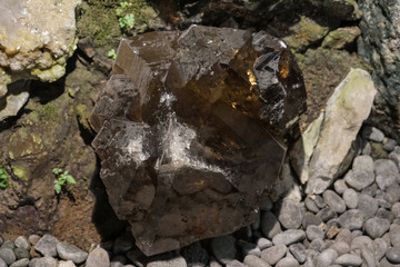 Raw cluster rough crystals close up in low light background