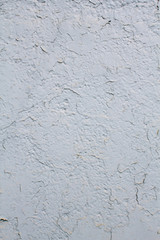 Texture of a wall painted with cracked white paint