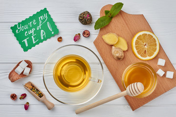 Herbal tea, honey, ginger, lemon and mint. You are muy cup of tea concept. Healthy eating and diet.