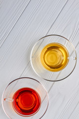 Top view on cups with aromatic tea. Two glass cups with hot tea, vertical image.