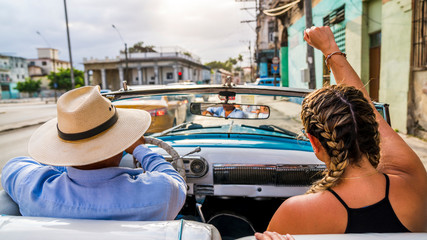 Havana Cuba. View from inside an old vintage classic American car. Close up of the driver and passenger.