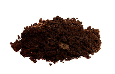 a pile of black soil on an isolated white background.