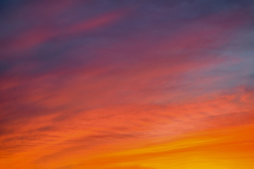 Blue sky with gold clouds - dramatic sunset, beautiful natural background. Setting sun illuminates the clouds.