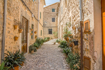 typical mediterranean cobblestone street in Valldemossa, Mallorca, Spain