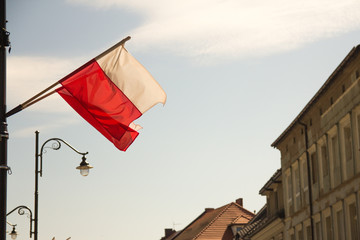 Polish flag waving on the city street