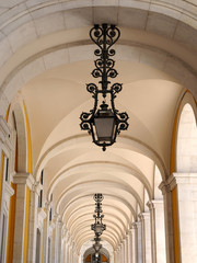 Beautiful arcades in Lisbon with traditional lamps