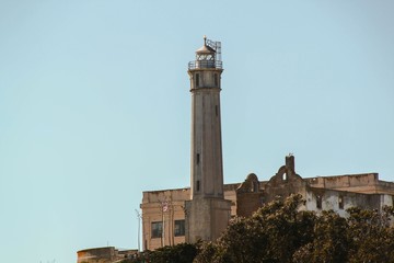 View on Prison Alcatraz. Lighthouse on blue sky background.  Alcatraz island background. San Francisco. USA. 
