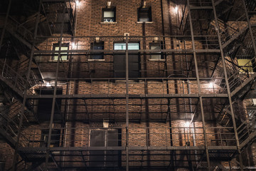 Facade of a typical old New York City building at night - New York City, NY