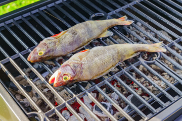 Grilled fresh fish. Cooking BBQ seafood on fire outdoors.