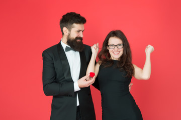 finally. valentines day celebration. happy sexy couple in love. tuxedo man and lady at engagement celebration. bearded man make woman marriage proposal. formal couple. ring in box. love date. yes