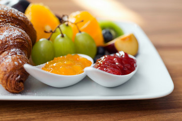 Close up of breakfast plate - fresh fruit and jam