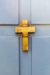 Golden christian old cross on wooden background. Symbol of religion, faith in God.