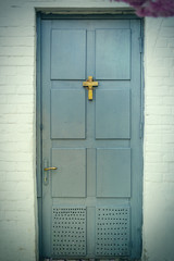 Wooden old door with a christian cross. The concept of religiosity, the path to God.