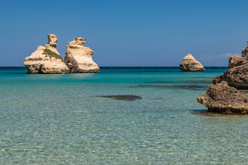The bay of Torre dell'Orso, with its high cliffs, in Salento, Puglia, Italy. Turquoise sea and blue...