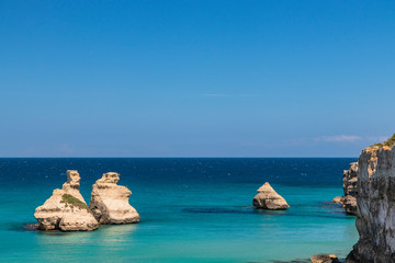 The bay of Torre dell'Orso, with its high cliffs, in Salento, Puglia, Italy. Turquoise sea and blue...
