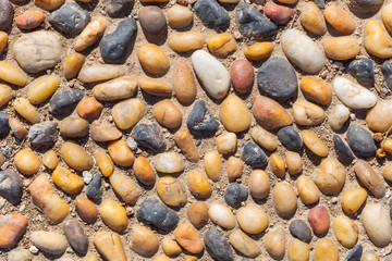 The pattern on the floor of light and dark pebbles. Modern mosaic of natural material.