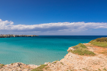 The bay of Torre dell'Orso, with its high cliffs, in Salento, Puglia, Italy. Turquoise sea and blue...