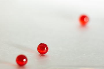 Red transparent medical capsules, soft focus