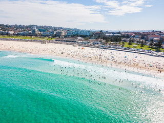 An aerial view of Bondi Beach in Sydney, Australia on a busy day with blue water