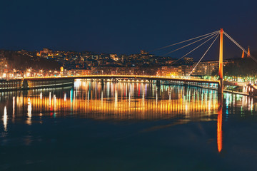 Fototapeta na wymiar Night view on Passerelle du Palais de Justice and Saone river. Lyon, France