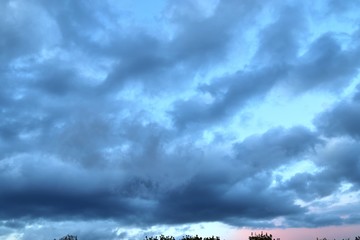 Dark forming clouds on a blue sky right before a rain shower