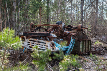 Fototapeta na wymiar Broken and abandoned rusty track ZIL lays upside down in Chernobyl Exclusion Zone