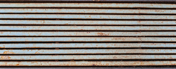 half-rusted rainfall lattice looking like horizontal  metal stripes