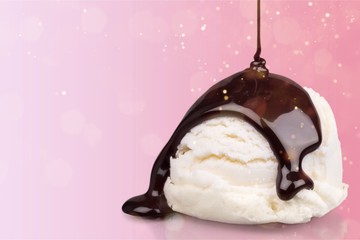 Vanilla ice cream with chocolate sauce on white background