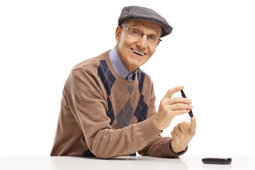 Senior man with a diabetes measuring device