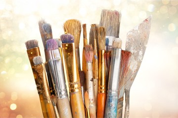 Row of artist paint brushes  on background