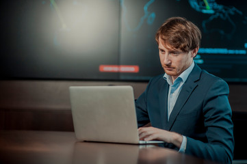  Young it engeneer business man with thin modern aluminium laptop in network server room