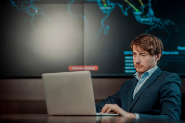  Young it engeneer business man with thin modern aluminium laptop in network server room