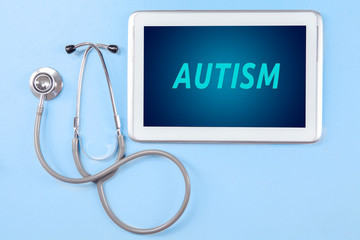 Digital tablet with autism word and stethoscope