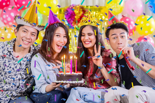 Four young people celebrating birthday party