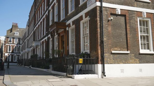 A row of terraced houses on a street.