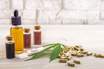 Full spectrum Cannabidiol CBD oils, capsules and crystals isolate on wooden backdrop