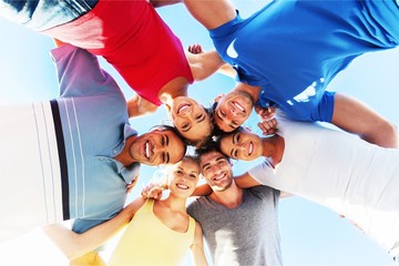 Group of happy young people in circle outdoors