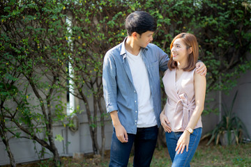 Beautiful portrait couple looking each others eyes and smiling with happy, young asian man and woman relation with love dating, husband and wife feeling and emotion, lovers and lifestyle concept.