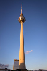 Full height TV tower at Alexanderplatz with bright blue sky at the evening with wonderful sunlight coming from the left