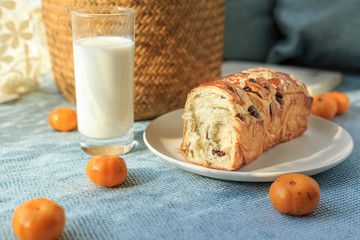 Bread, milk, fruit and flowers on the table