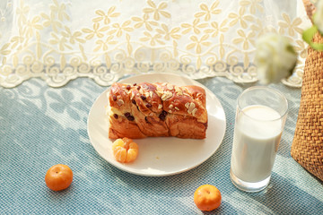Bread, milk, fruit and flowers on the table
