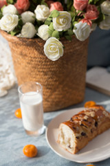 Bread, milk, fruit and flowers on the table
