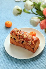 Bread, milk, fruit and flowers on the table