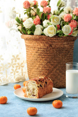 Bread, milk, fruit and flowers on the table