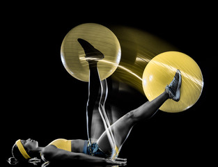 one mixed race woman exercising fitness exercises isolated on black background with lightpainting effect multiple exposures