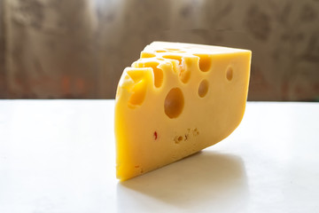Piece of cheese with large holes