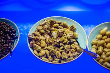 plate of pitted olives, pork smoked olives